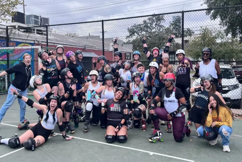 A group of women in roller derby gear pose for a picture