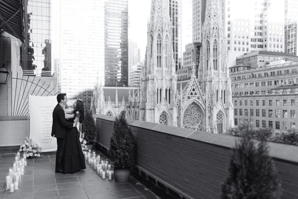 A couple gets engaged in front of a beautiful city backdrop, planned by The Yes Girls