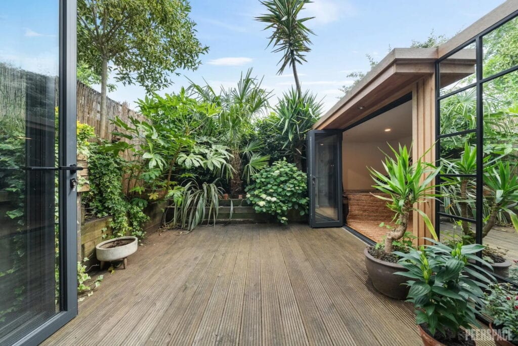 Lush greenery surrounds a small rooftop