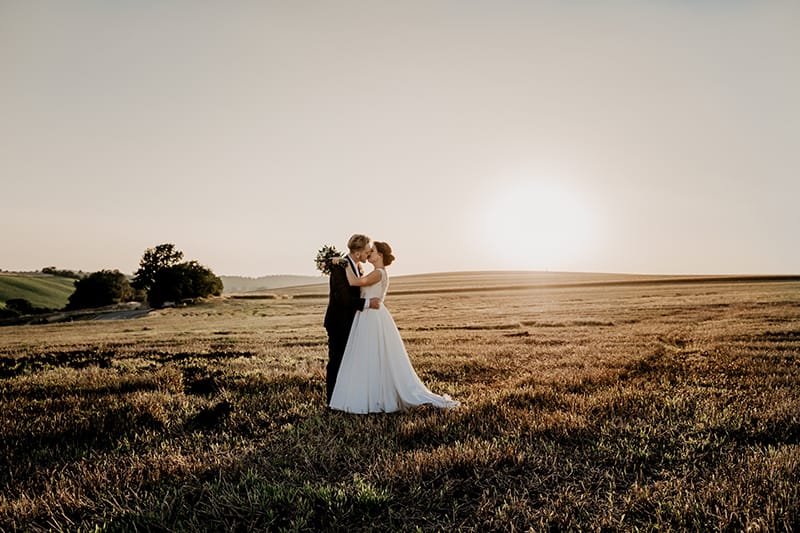 bride and groom in field