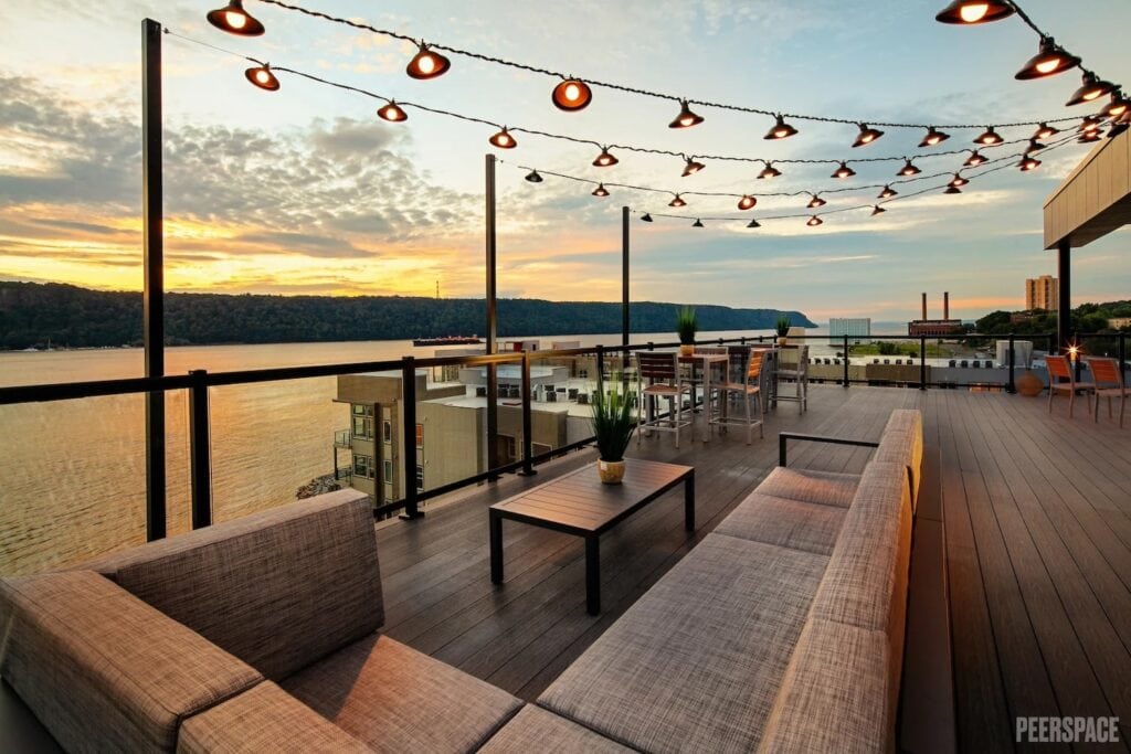 A beautiful rooftop is lit up during sunset along the Hudson River