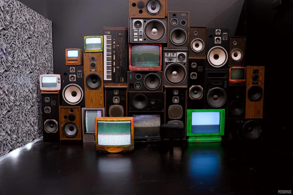A wall of vintage televisions and speakers