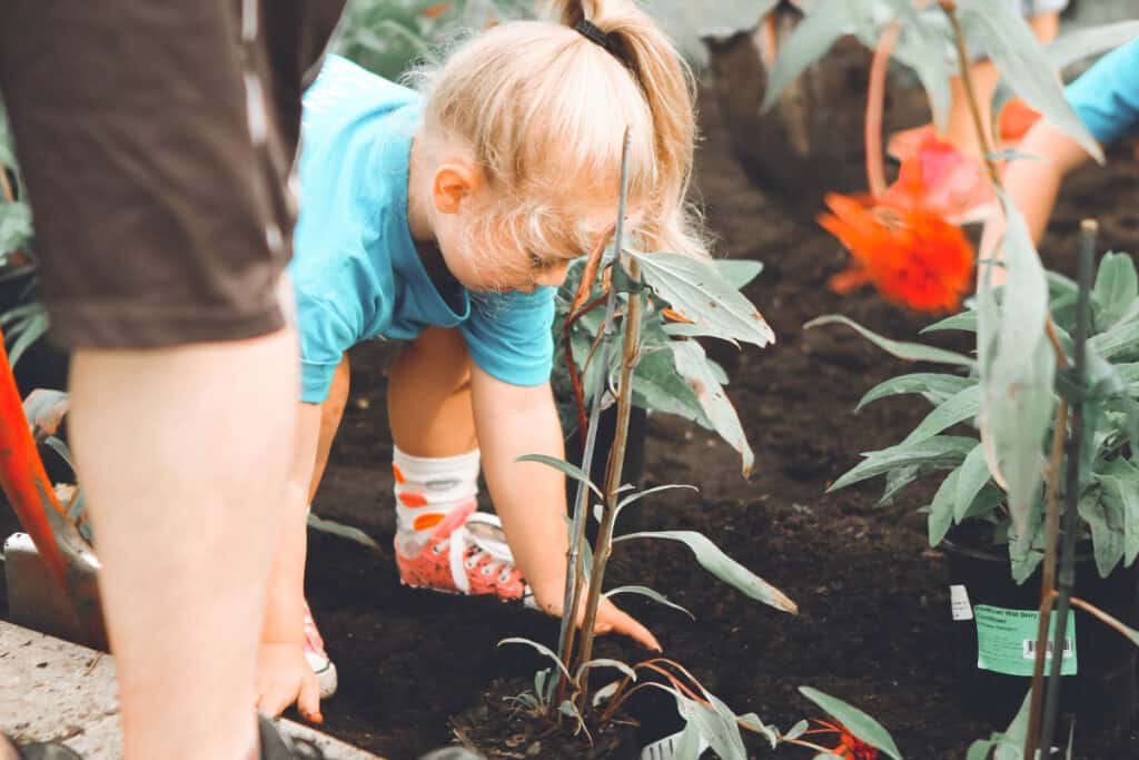 a child helping plant a garden for charity