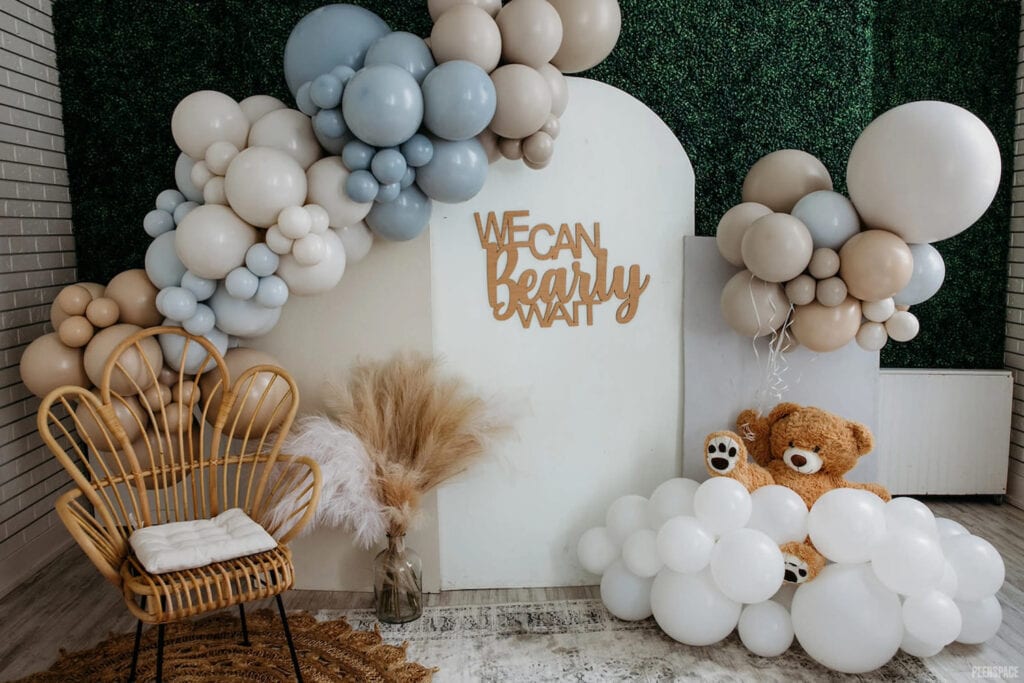 Teddy bear-themed baby event is decorated with baby blue, white and neutral balloons