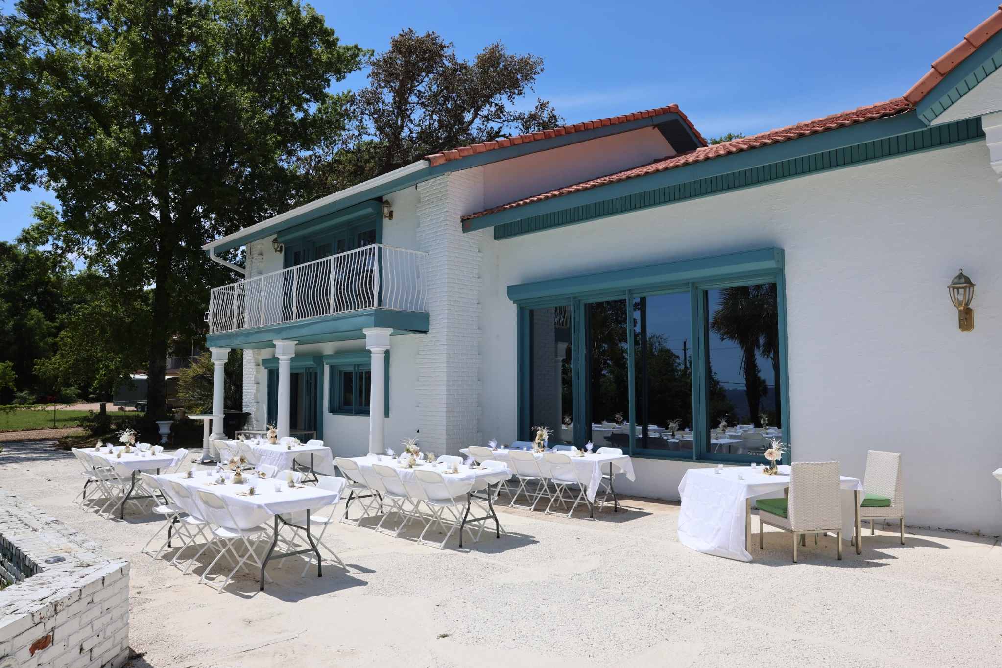 Alabama waterfront venue with round reception tables and formal seating