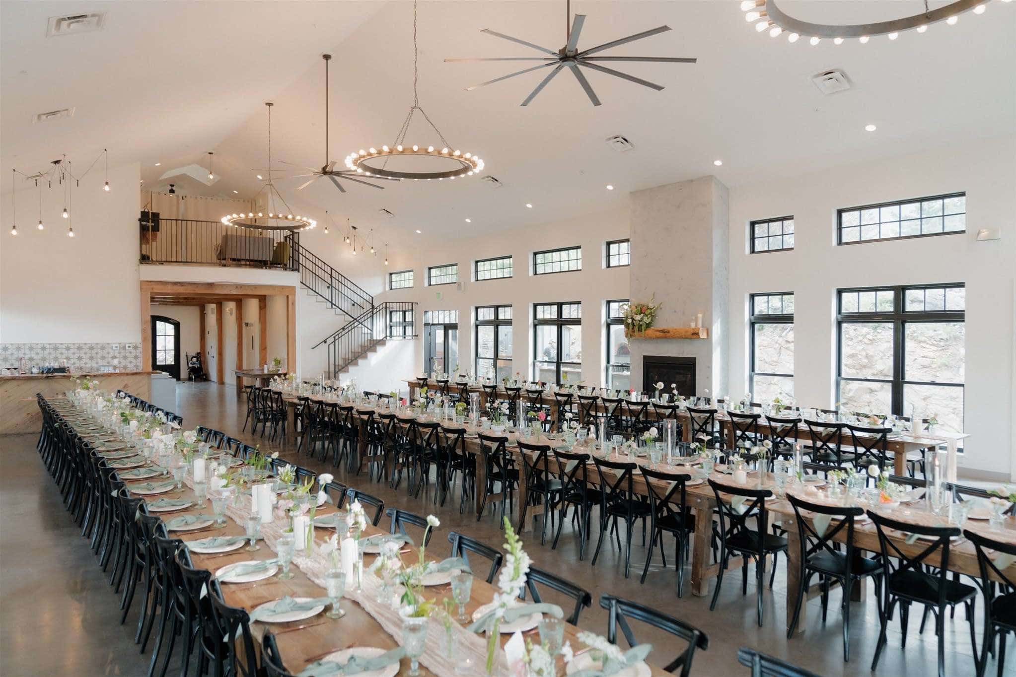Modern Alaska event venue with reception tables and mountain views