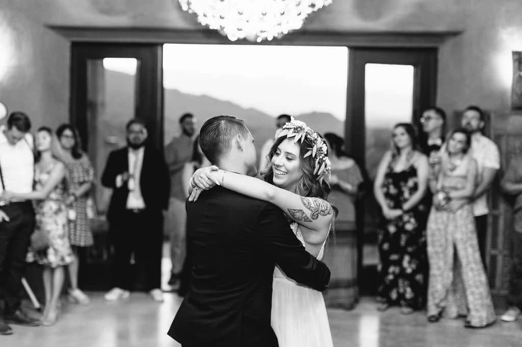 Couple dancing at an indoor Albuquerque wedding reception with mountain views