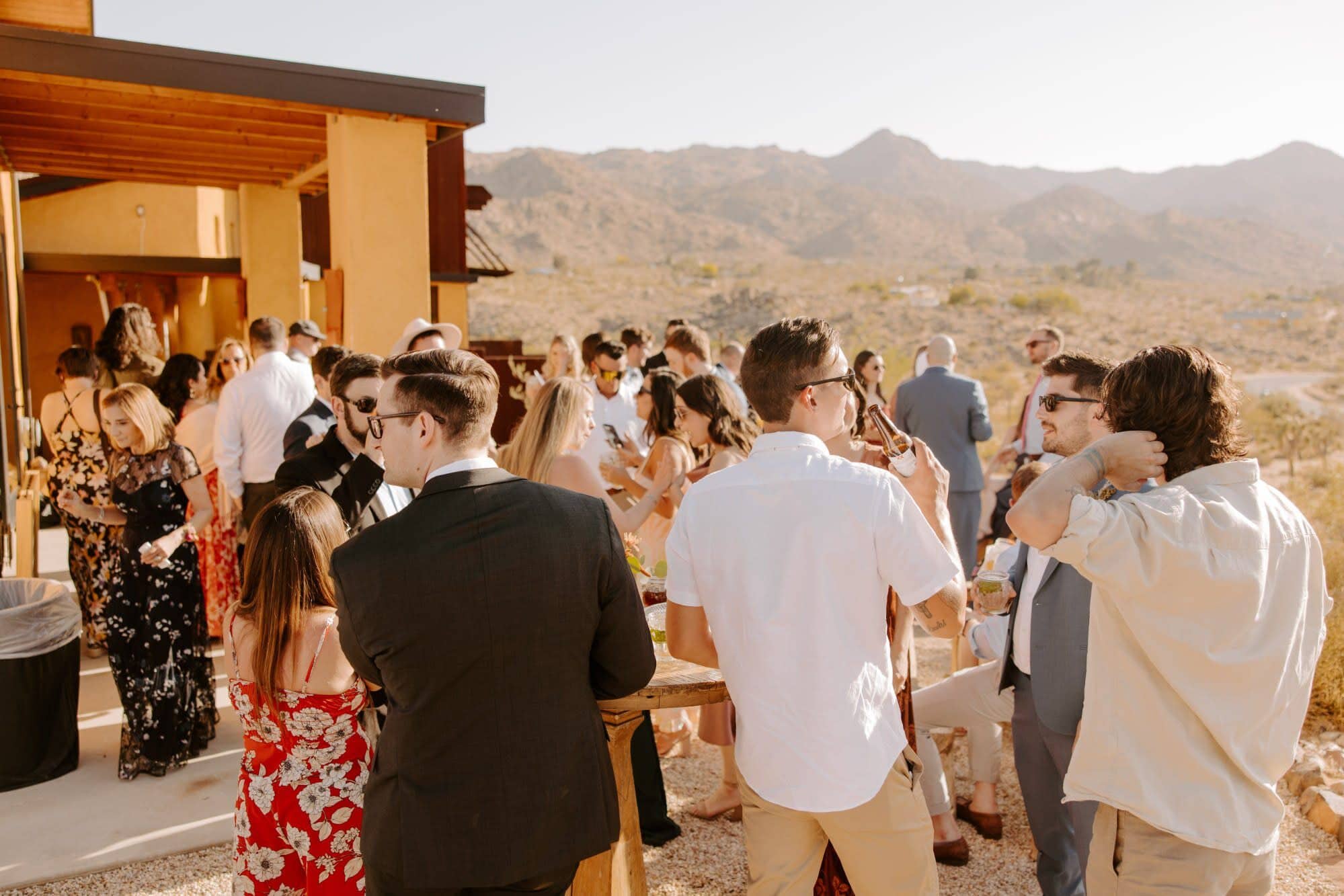Guests mingling on a patio overlooking the Albuquerque desert landscape