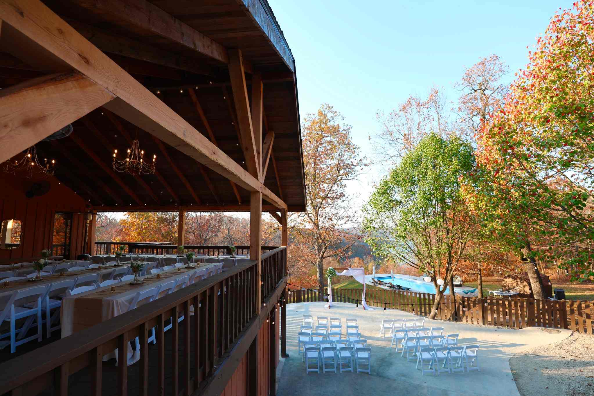 Rustic Arkansas wedding venue with autumn foliage and ceremony seating