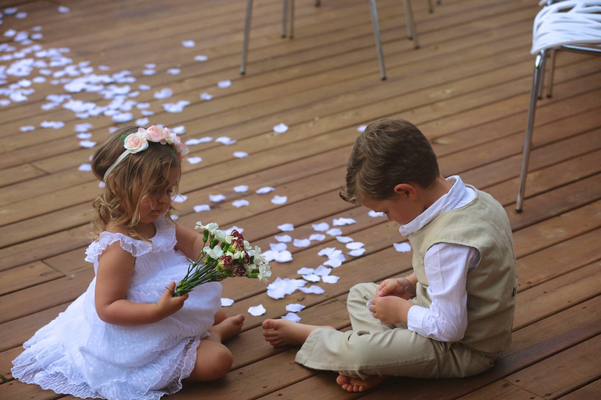 Children with flower crowns sharing a sweet moment at Arkansas wedding