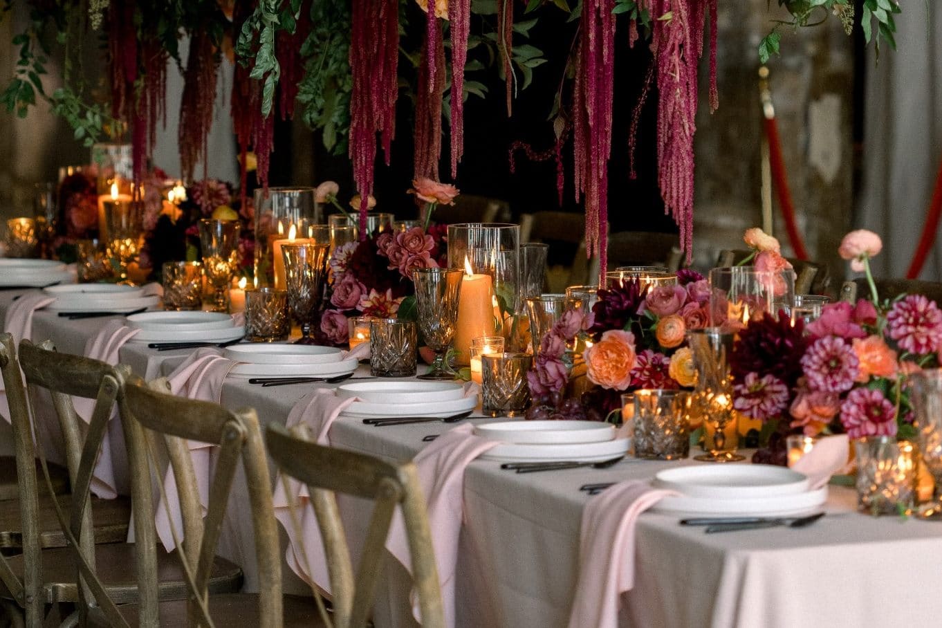 Candlelit Baton Rouge wedding reception table featuring hanging floral installation and decor