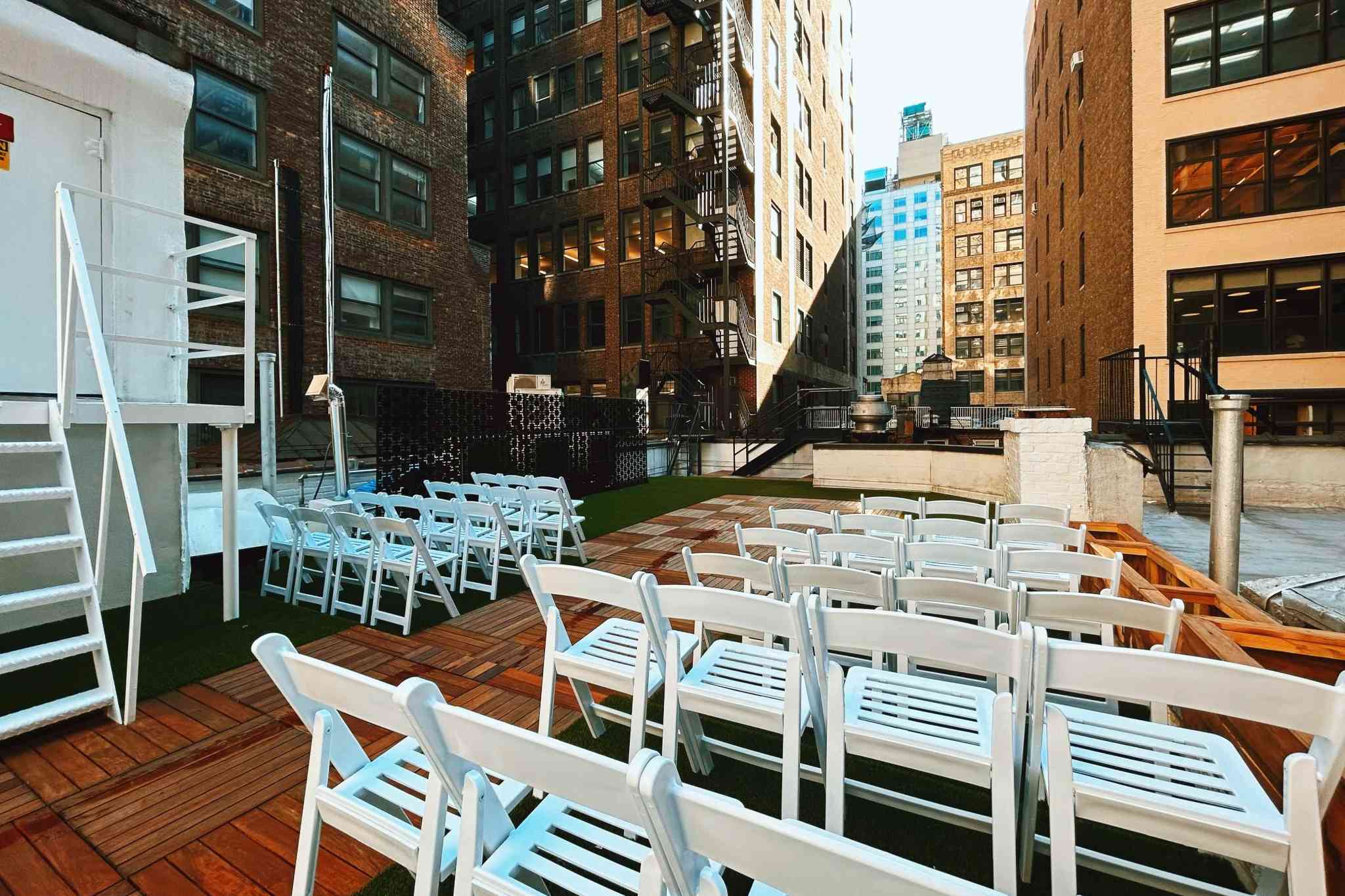 Brooklyn rooftop wedding ceremony setup with chairs and urban skyline