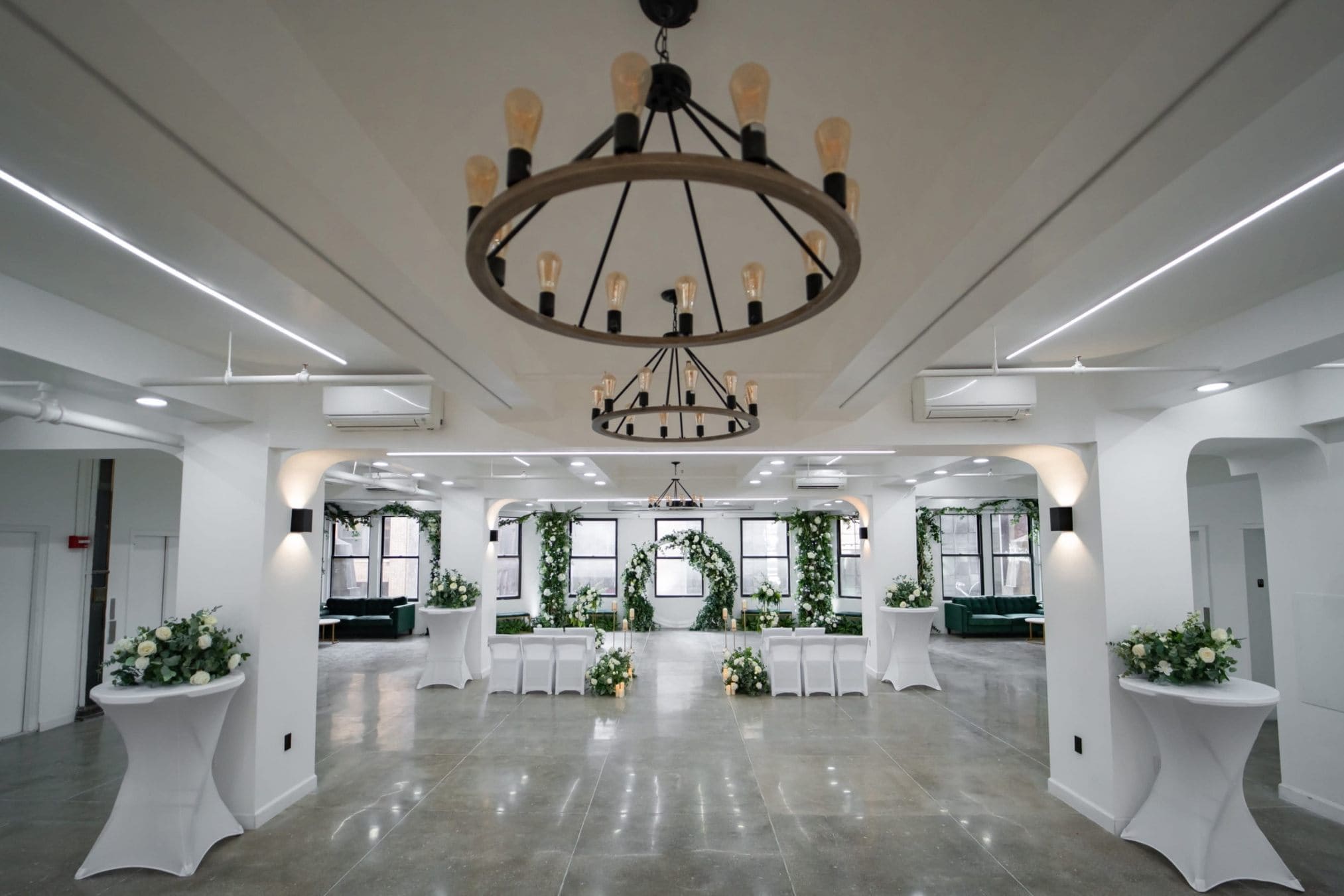 Elegant Brooklyn indoor wedding venue with floral pedestals and chandeliers
