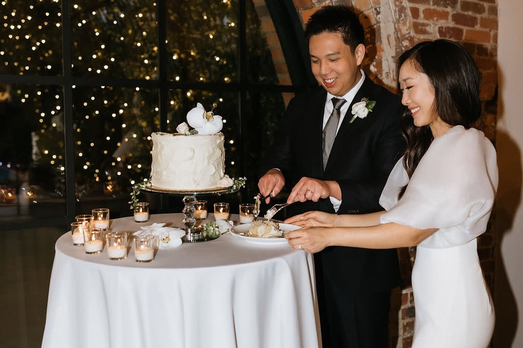 Bride and groom cutting cake at intimate Buffalo wedding reception venue