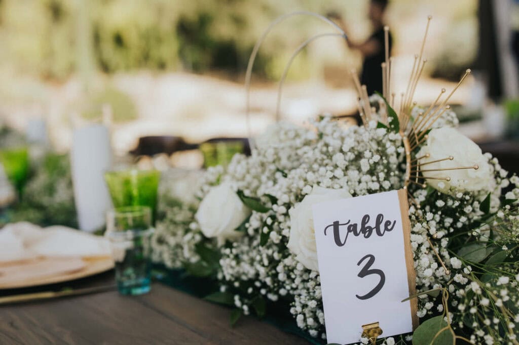 Elegant floral centerpiece and table setting detailed by Colorado wedding planners