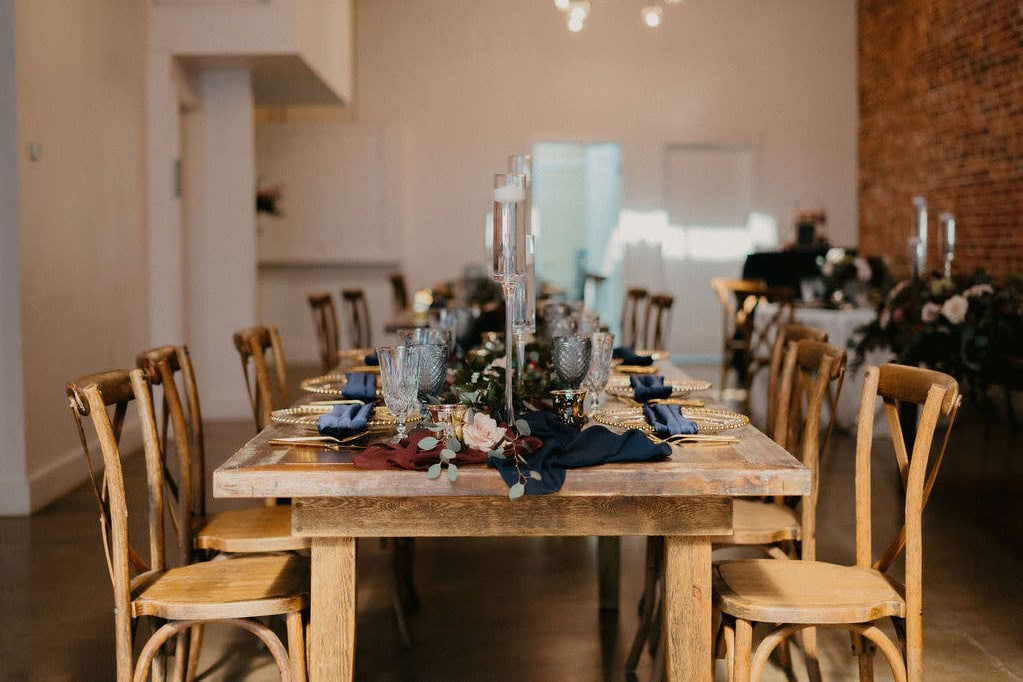 Polished indoor Delaware wedding reception with candlelight and floral design