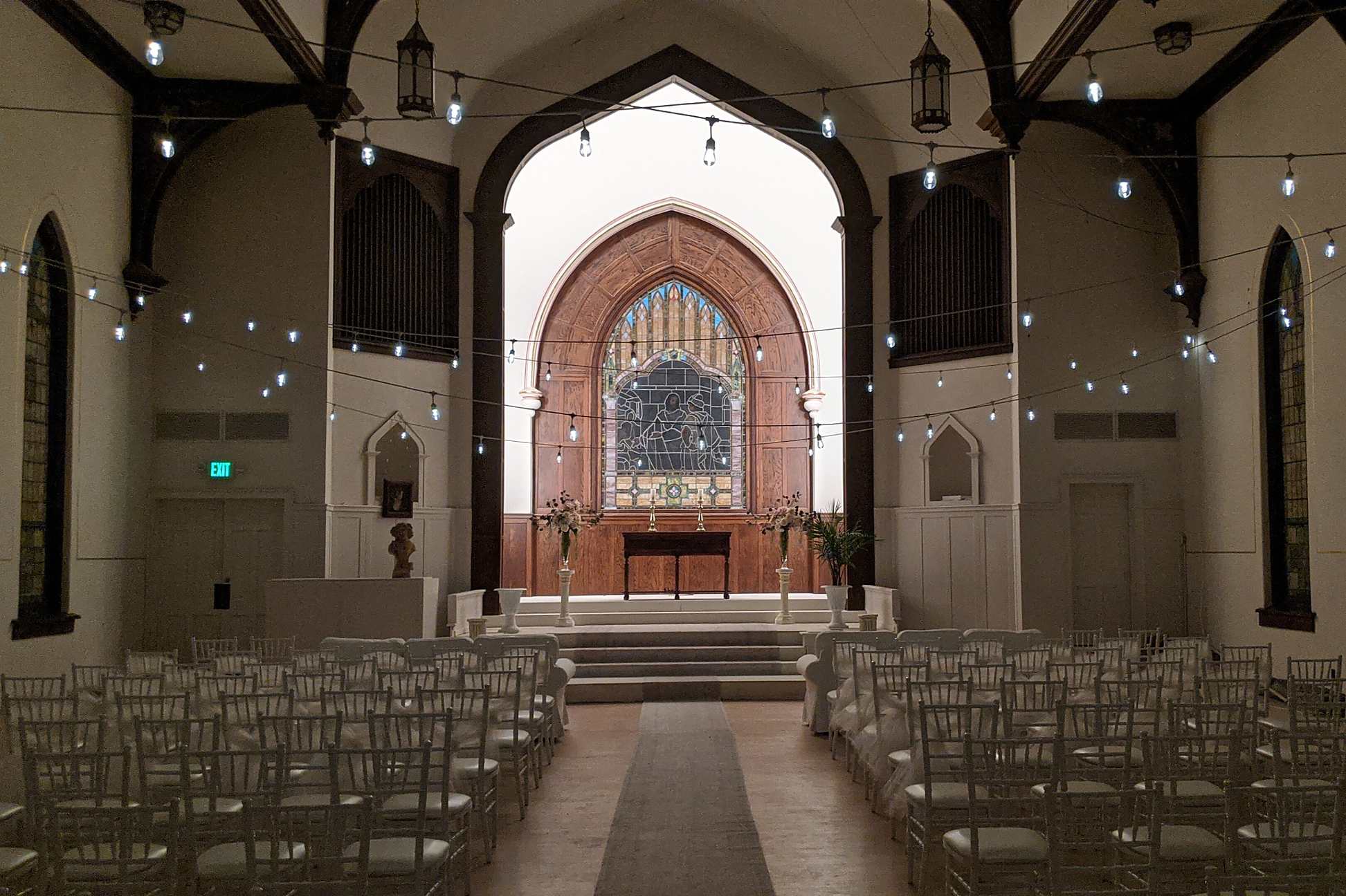 Fort Wayne wedding venue interior with pendant lights and altar styling