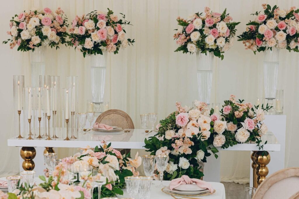 Indoor Georgia wedding venue with pink florals, white drapery, and table