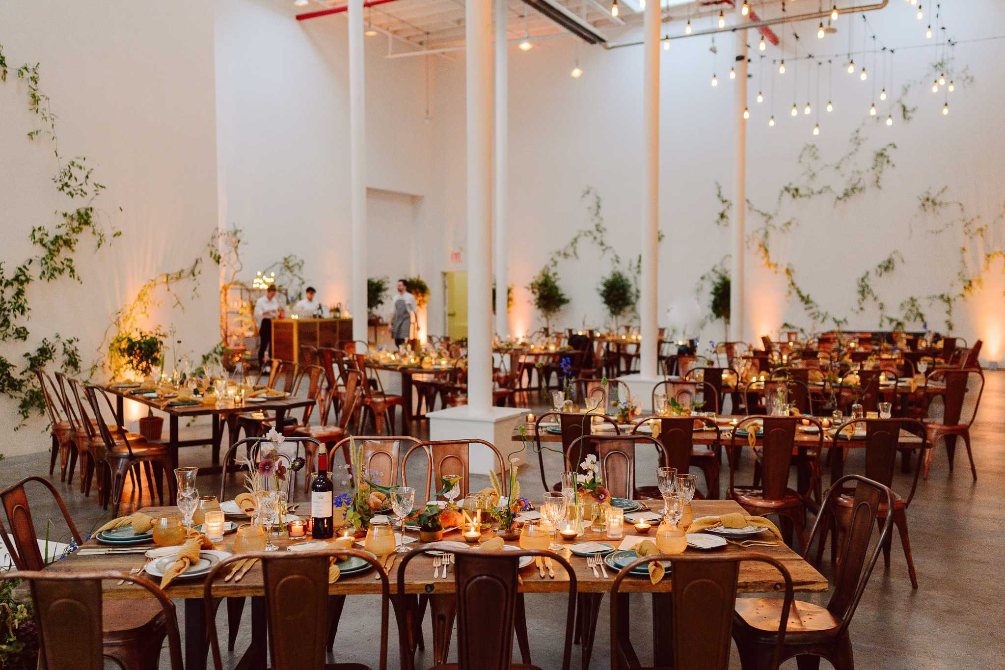 Elegant Greensboro wedding reception with pendant lights and greenery