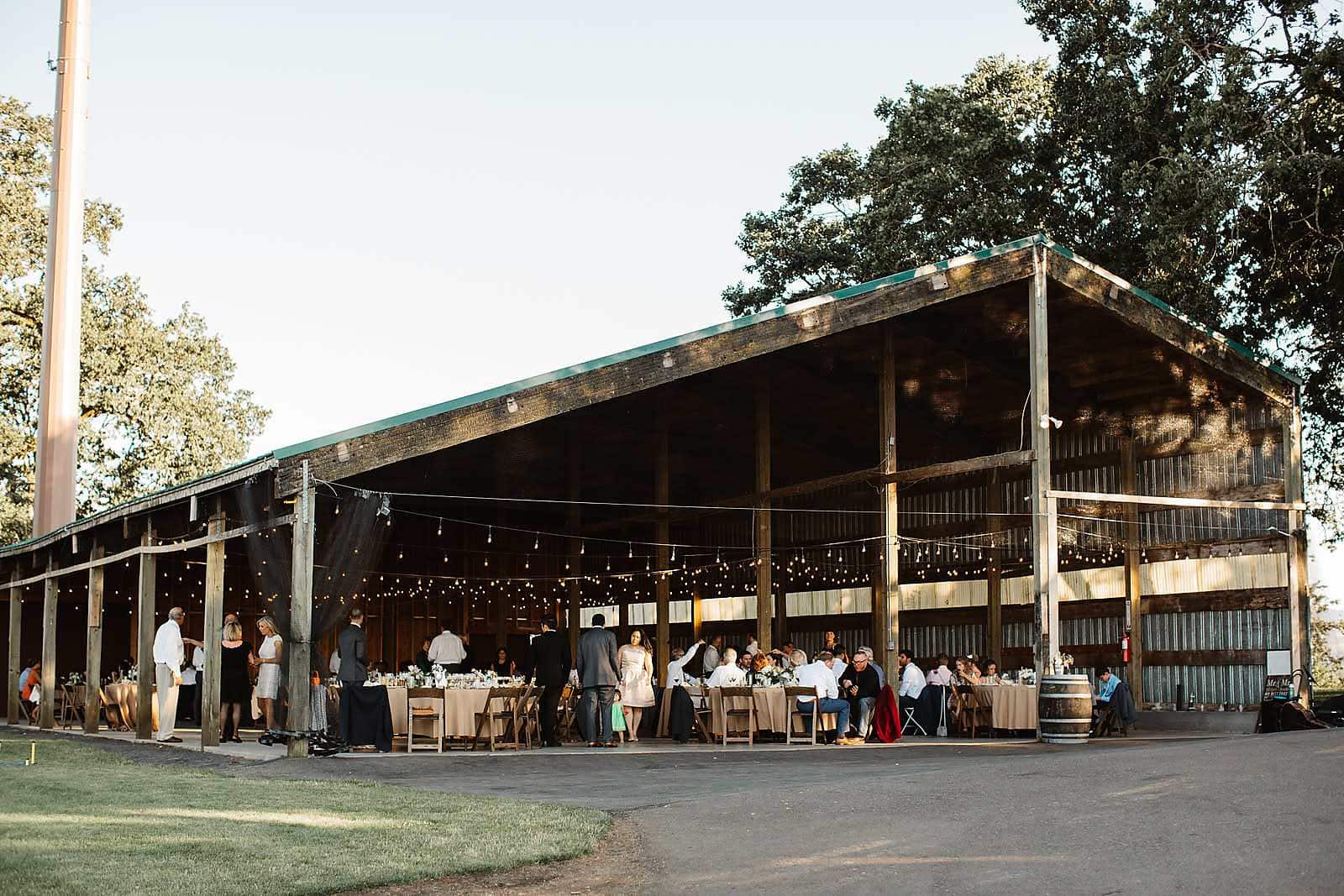 Rustic barn Idaho wedding reception venue with guests and string lights