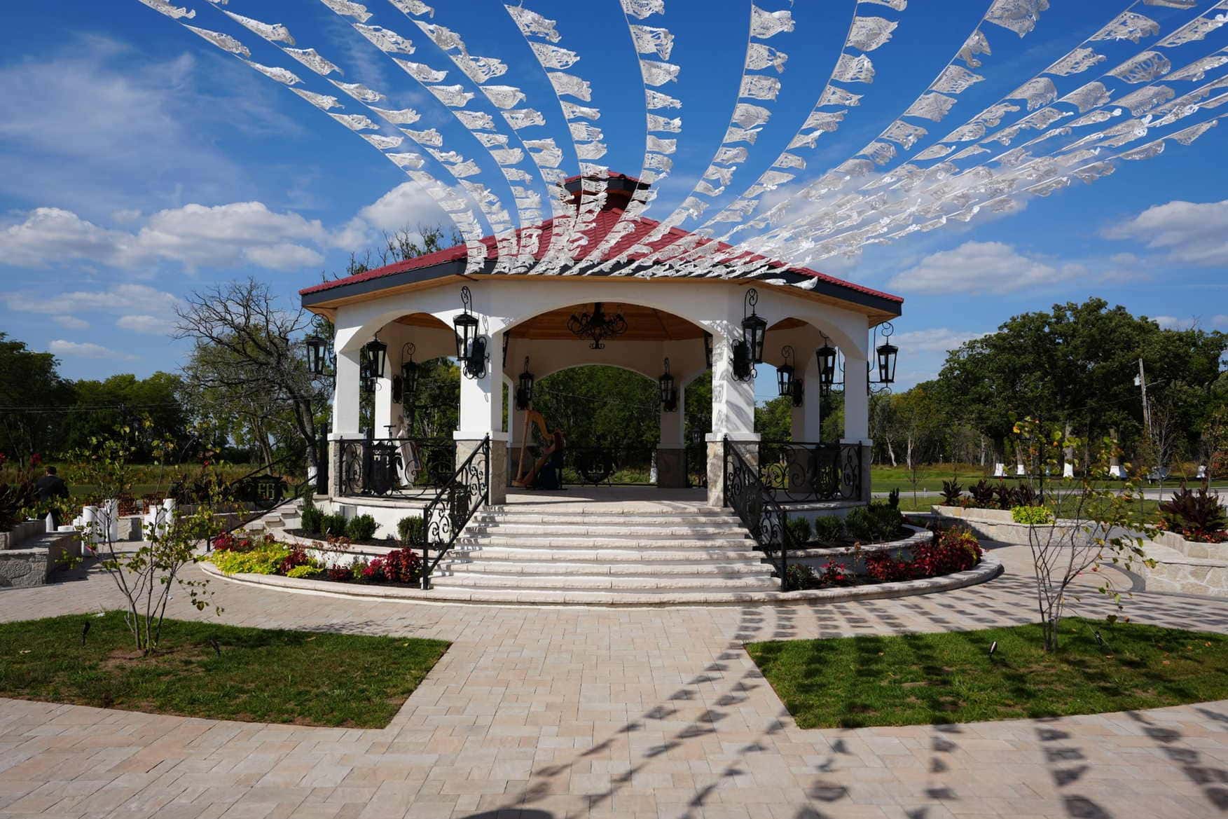 White gazebo with red-tiled pergola at Illinois wedding venue