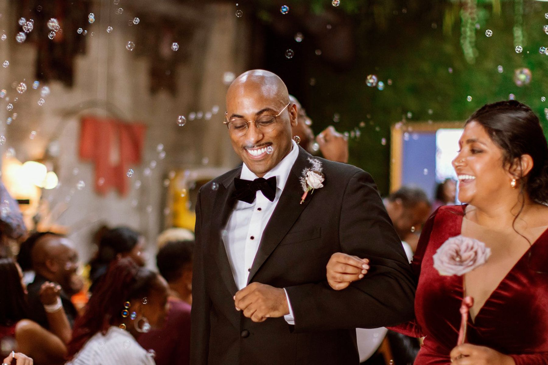 Couple in formal attire celebrating with bubbles at Iowa wedding