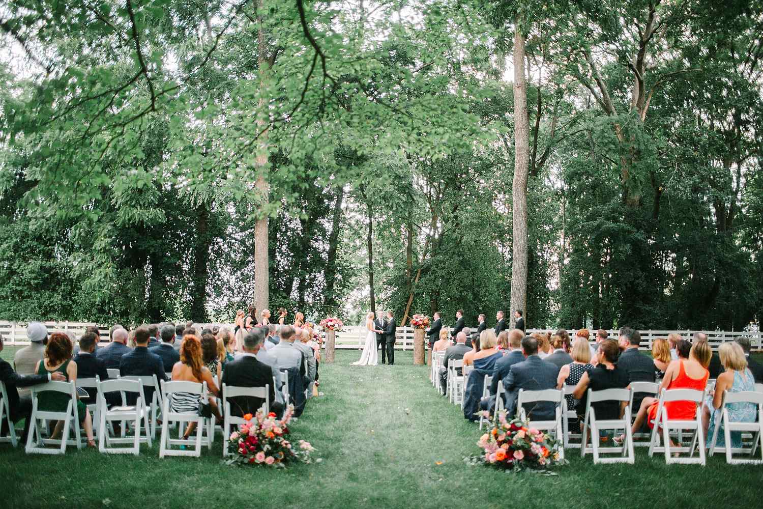 Outdoor Kentucky wedding ceremony with aisle florals and guests