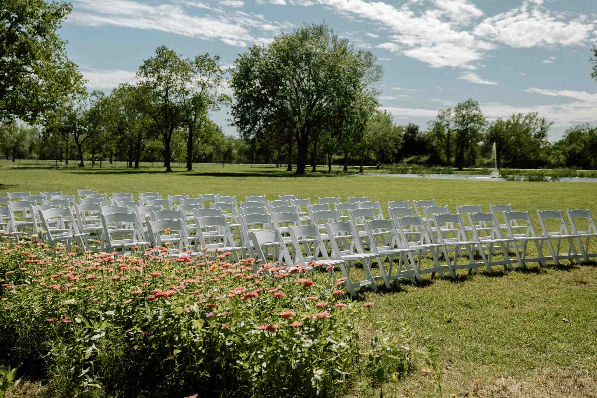 Wedding ceremony chairs and flower beds at Lincoln park venue with water views