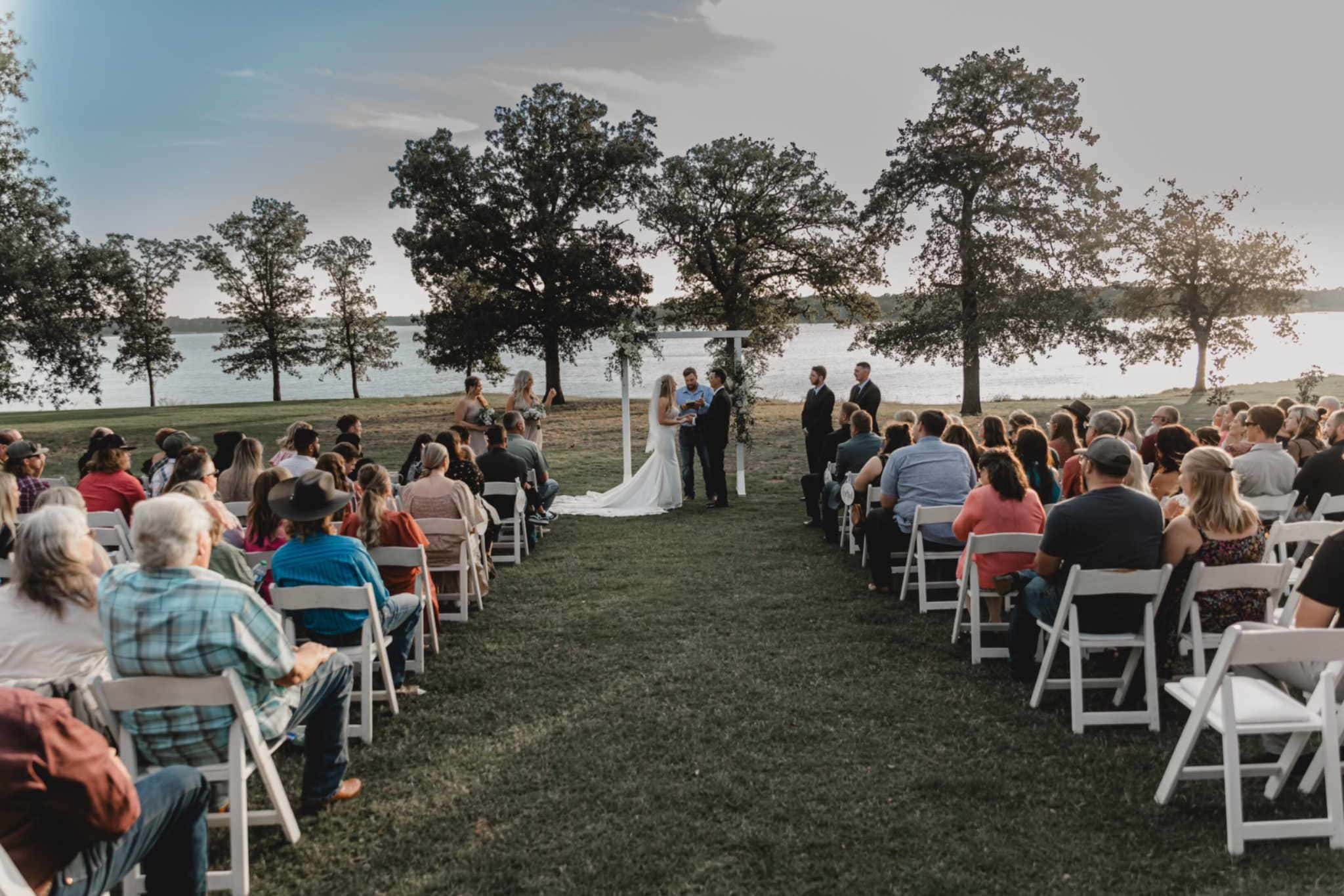 Outdoor lakeside wedding ceremony setup with chairs and arbor in Lincoln