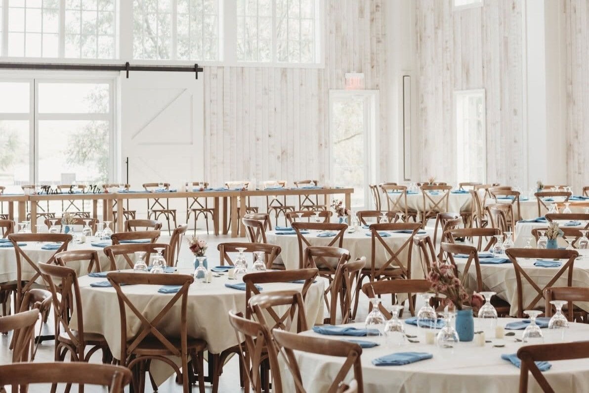 Lincoln wedding reception hall with farmhouse tables and blue napkin place settings