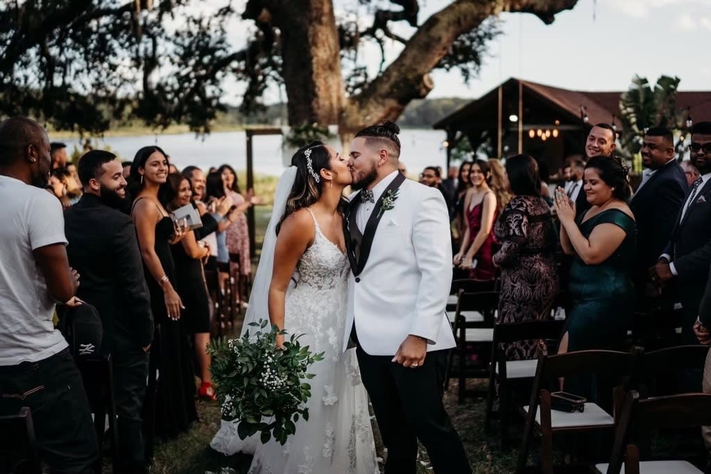 Outdoor Louisiana wedding ceremony with lakeside waterfront backdrop