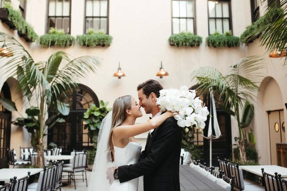 Bride and groom share intimate moment in Louisiana courtyard venue