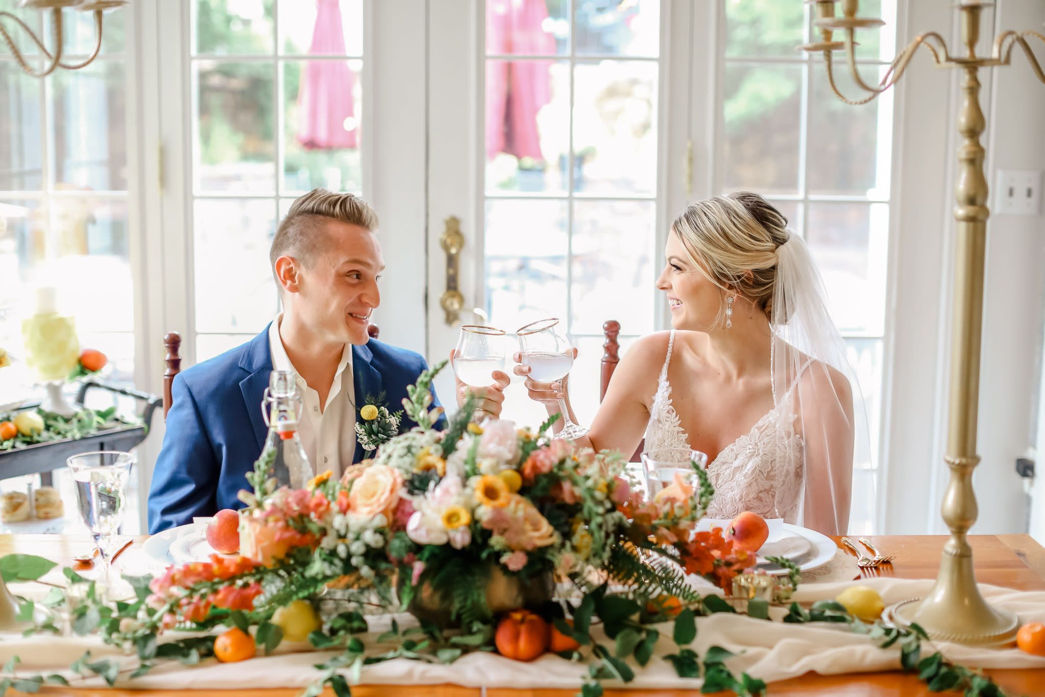 Bride and groom toasting at styled Missouri wedding reception table