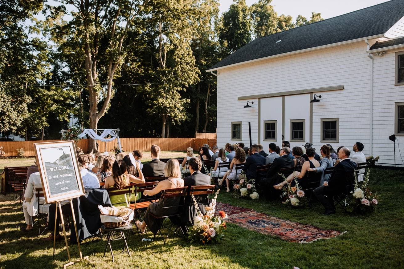Outdoor wedding ceremony with guests seated on lawn in New Hampshire