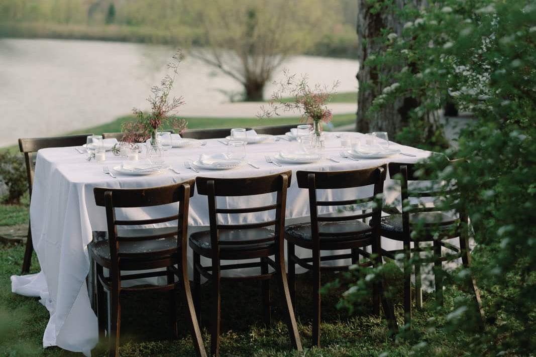 Elegant waterfront wedding reception dining table setup in North Carolina