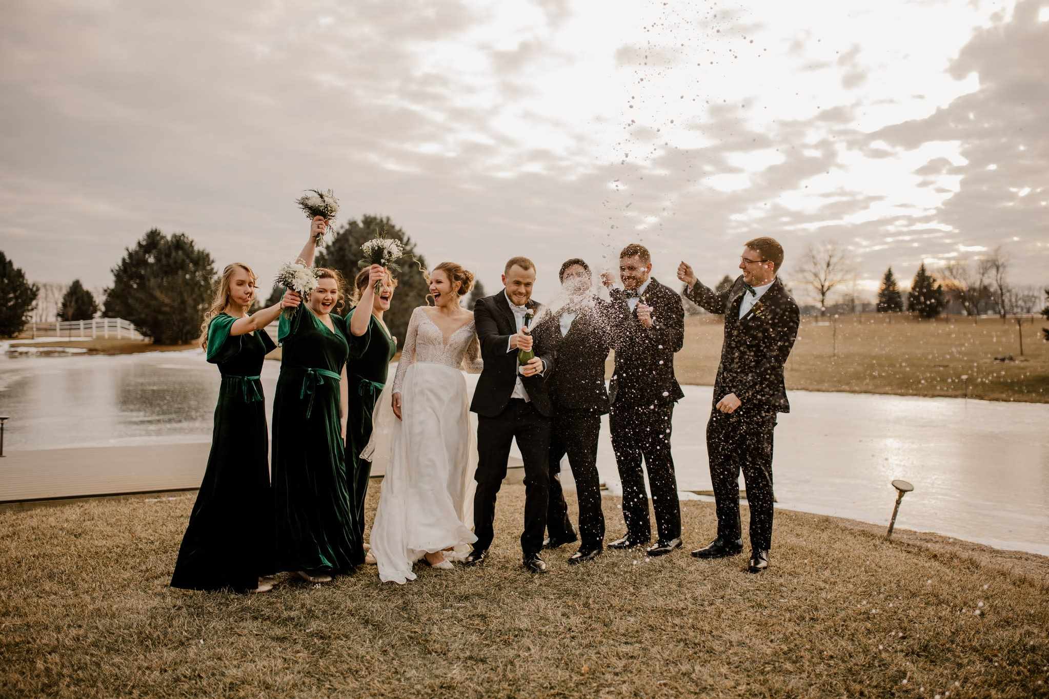 Ohio wedding party celebrating outdoors with confetti by pond
