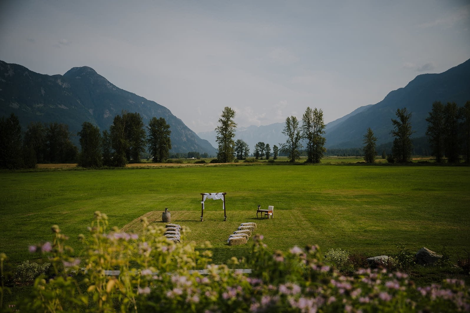 Alpine valley ceremony setup in Oregon with dramatic natural backdrop