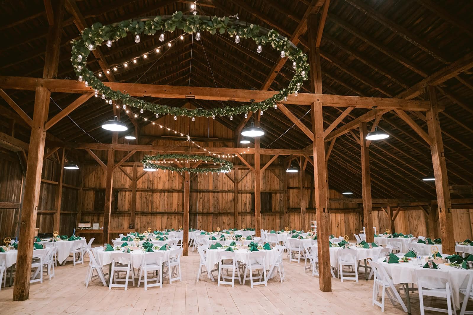 Decorated barn reception venue with tables and lighting in Pennsylvania