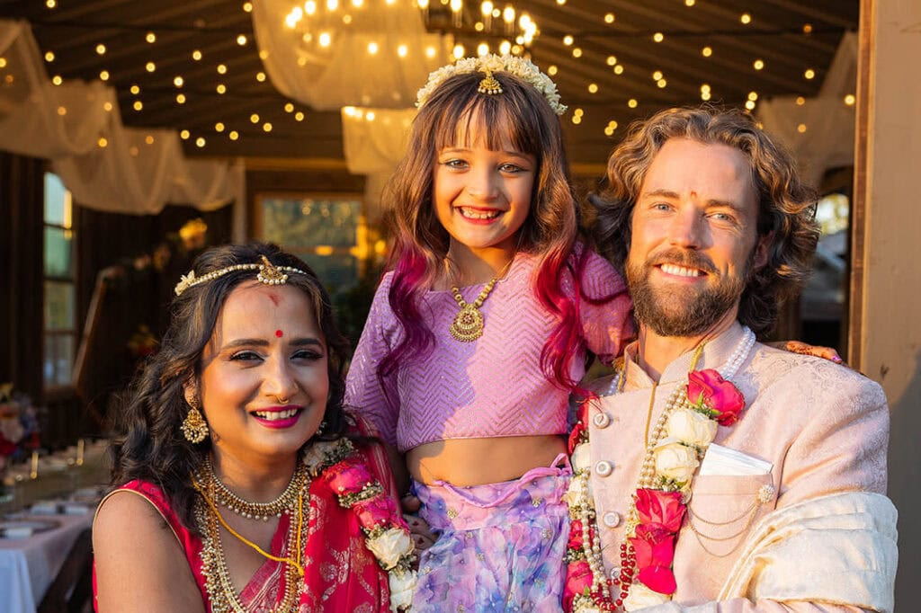 Happy family posing in traditional attire at a Philadelphia wedding reception