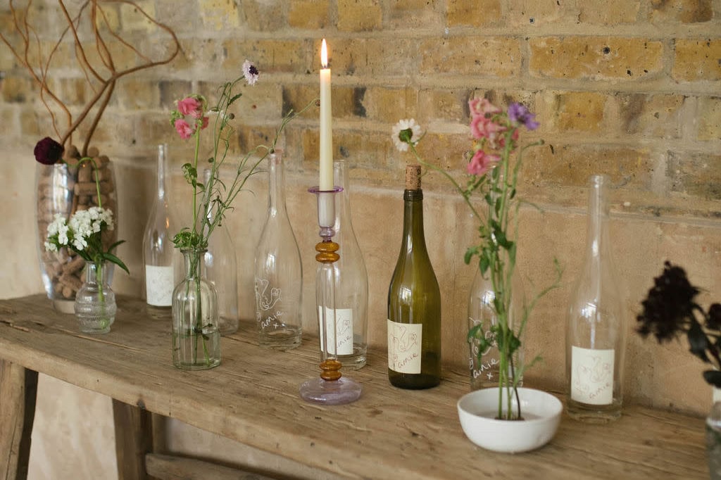 Intimate floral arrangement against brick wall for Raleigh wedding events