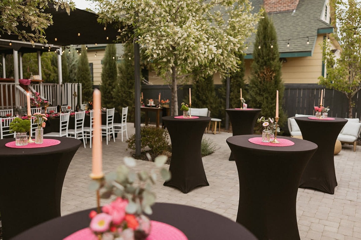 Upscale outdoor Reno wedding event setup with cocktail tables and florals