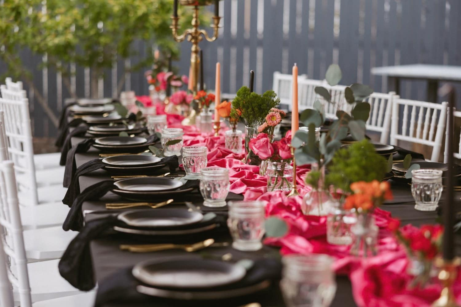 Styled Reno wedding reception table with pink florals and taper candles