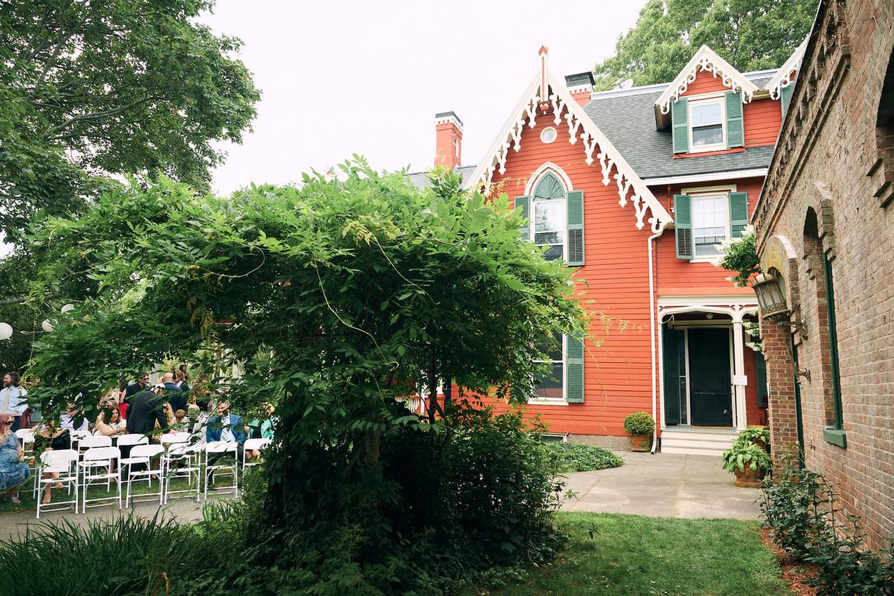 Guests seated under vine-covered arbor at Rhode Island historic property
