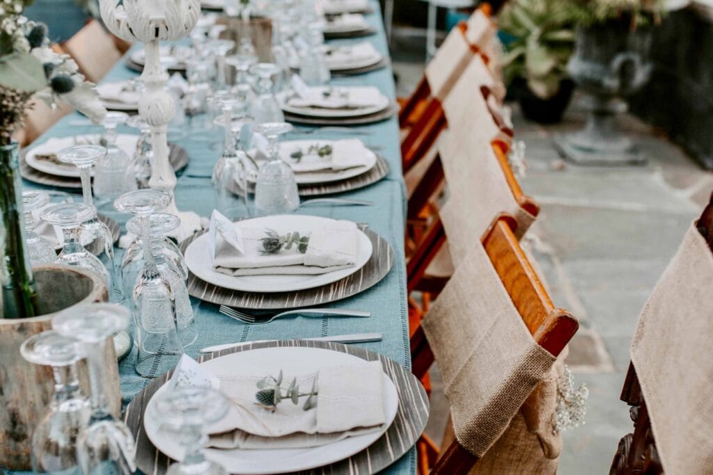 Elegant Richmond wedding reception table setting with blue linens and florals