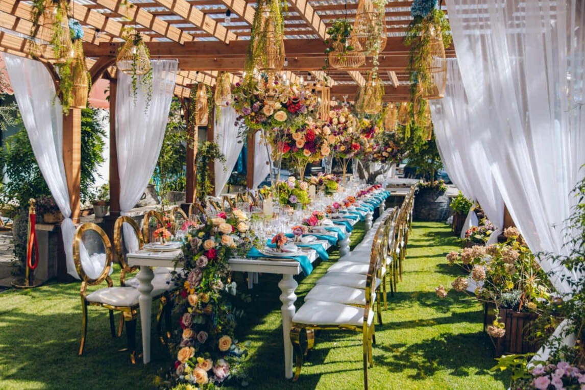 Elegant San Jose wedding reception tablescape under pergola with florals