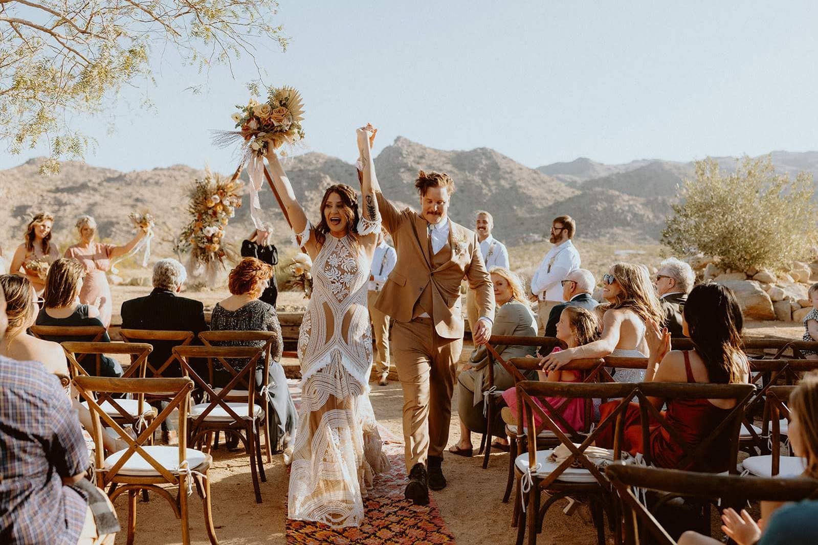 Bride and groom celebrating at an outdoor desert wedding ceremony in Scottsdale