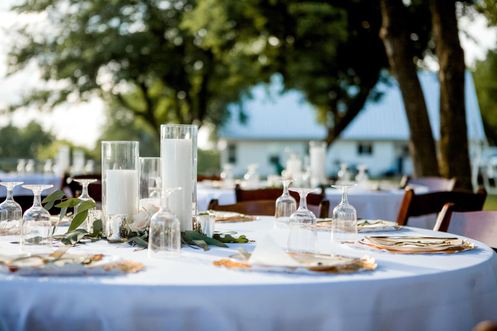 Elegant outdoor Texas wedding reception table set with candles and greenery