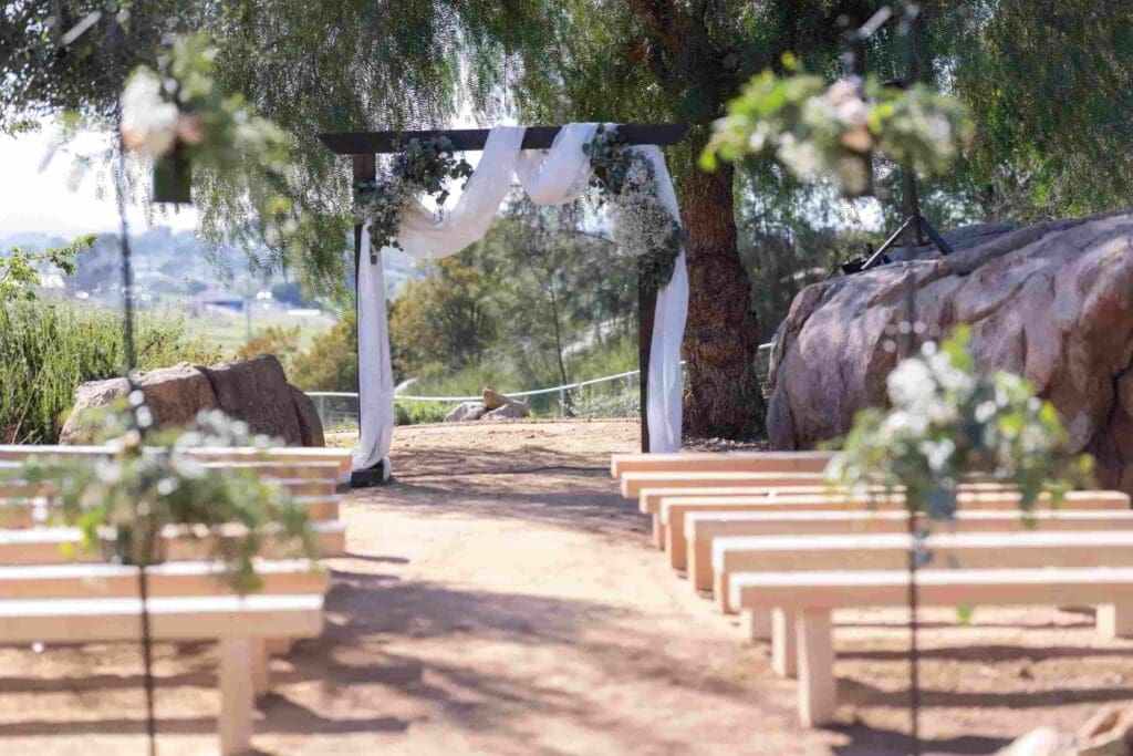 Rustic outdoor wedding ceremony setup with wooden arch in Utah nature