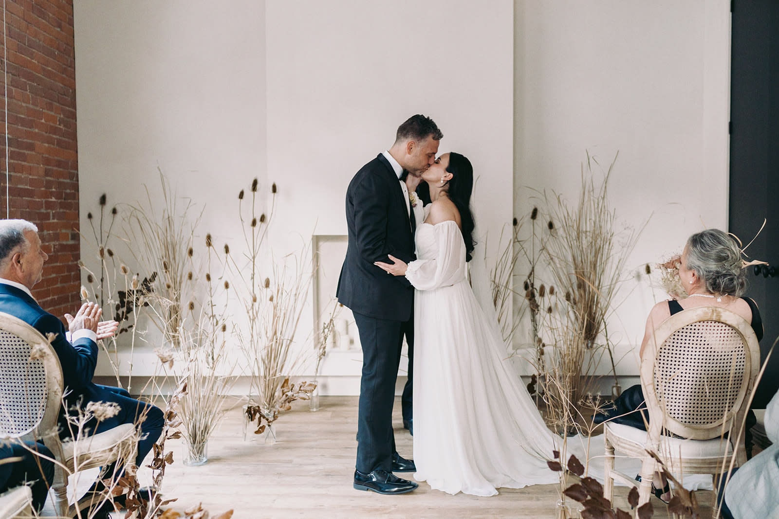 Couple kissing at altar in minimalist Wichita wedding ceremony space