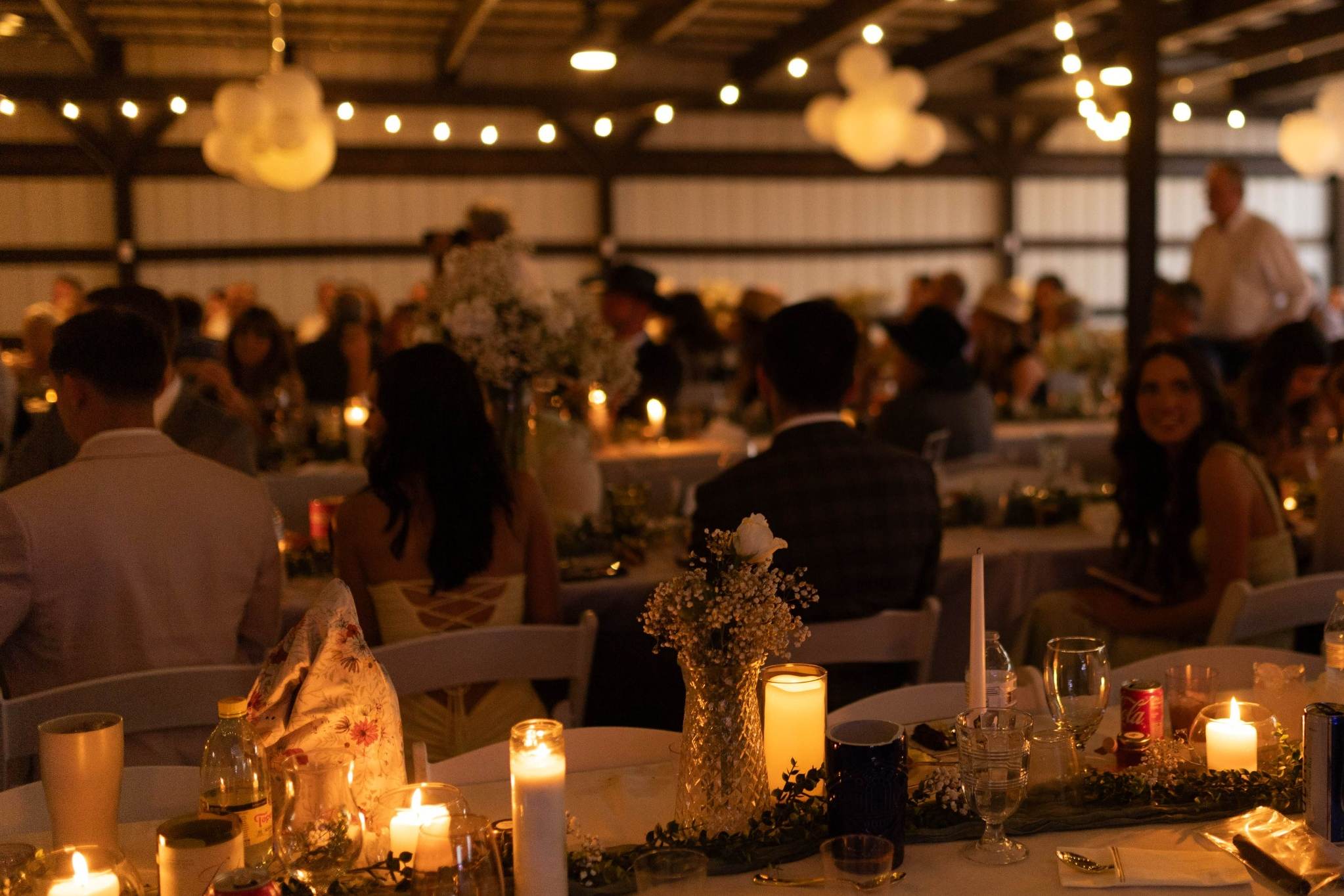 Elegant indoor Wisconsin wedding reception with candlelight and string lights